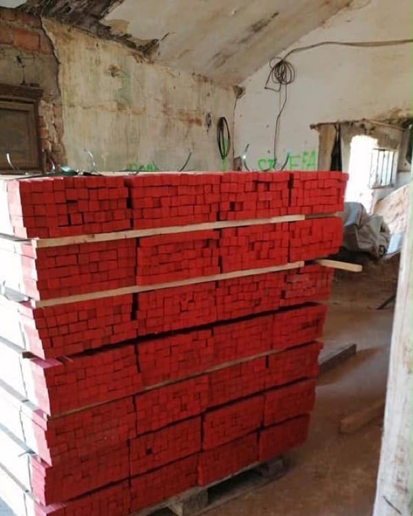 Wooden stakes with red-painted heads, on a pallet